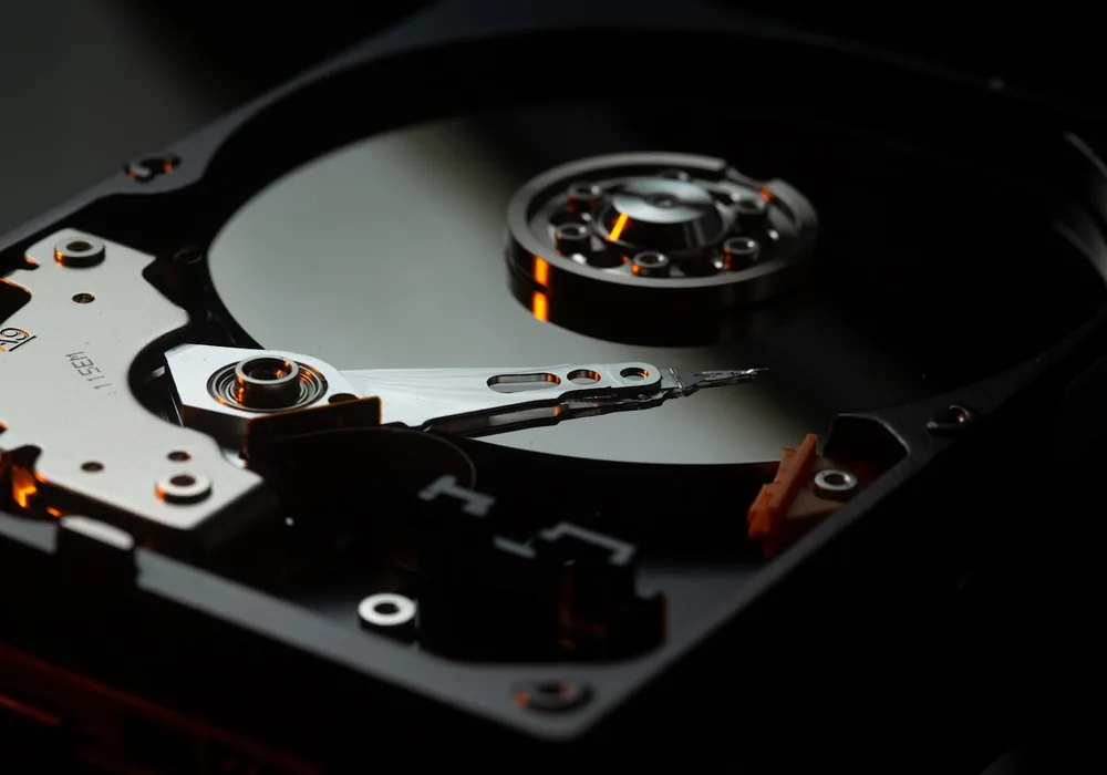 The platter and read head of an opened hard disk drive